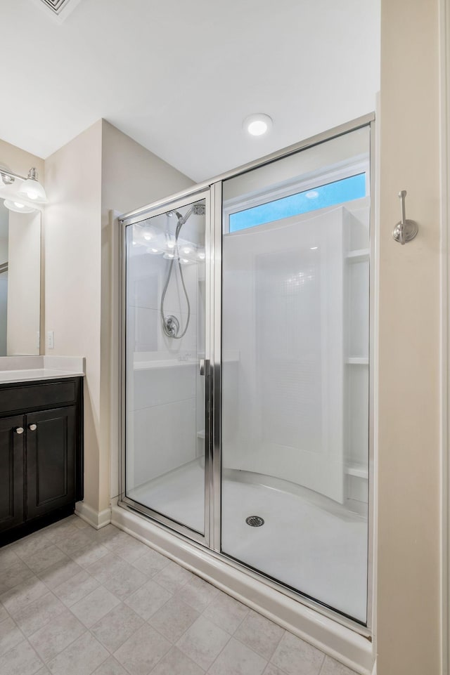 bathroom with a shower with door and vanity