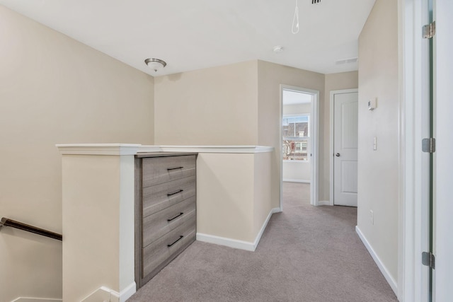 corridor featuring light colored carpet