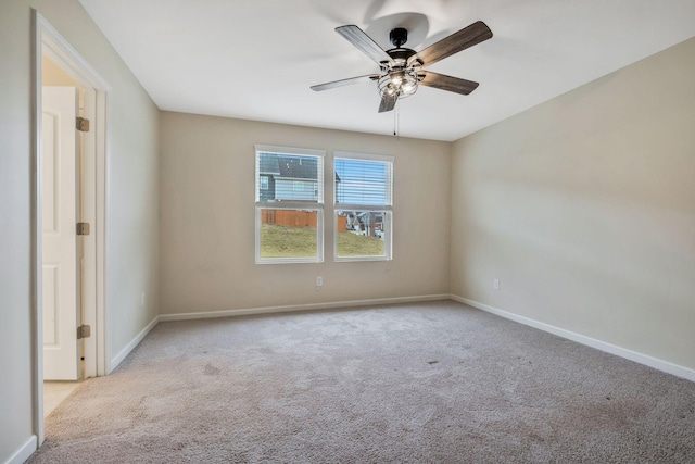 carpeted spare room with ceiling fan