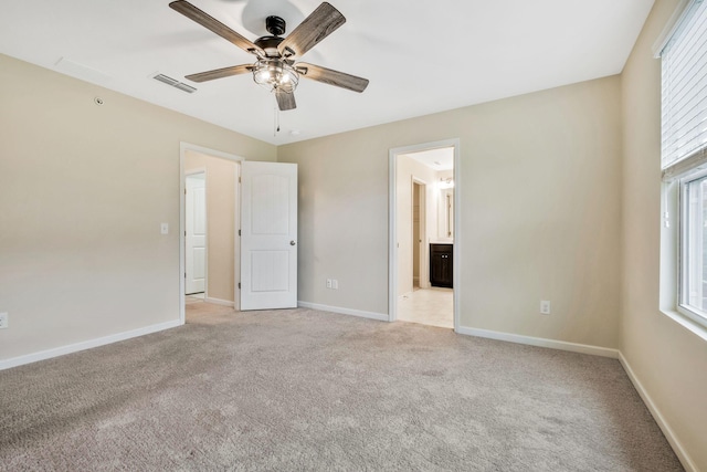 unfurnished bedroom with ceiling fan, connected bathroom, and light carpet