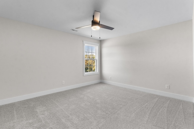 unfurnished room with ceiling fan and carpet