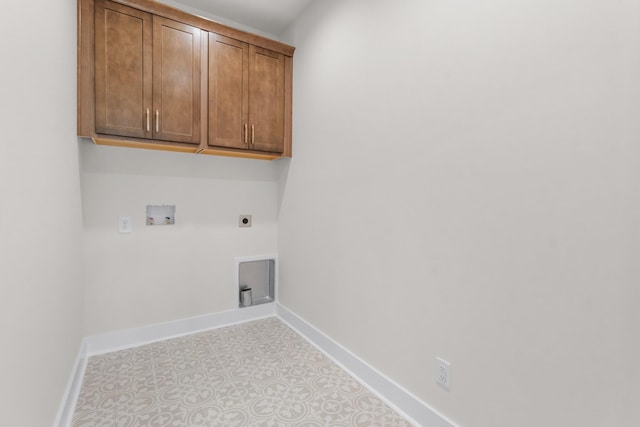 clothes washing area featuring cabinets, hookup for a washing machine, and hookup for an electric dryer