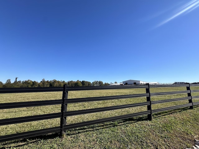 view of gate featuring a yard and a rural view