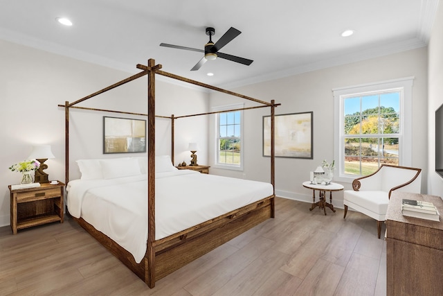 bedroom with ornamental molding, ceiling fan, and light wood-type flooring