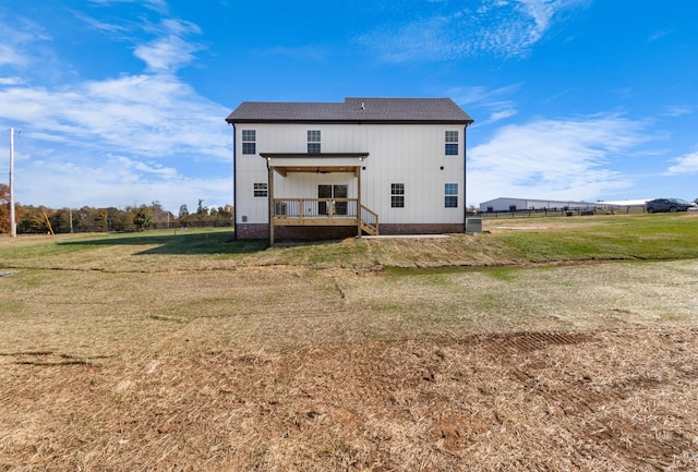 rear view of house featuring a lawn