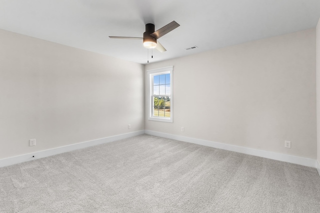 empty room with light colored carpet and ceiling fan