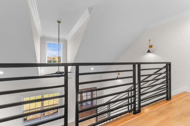 staircase featuring ornamental molding and hardwood / wood-style floors