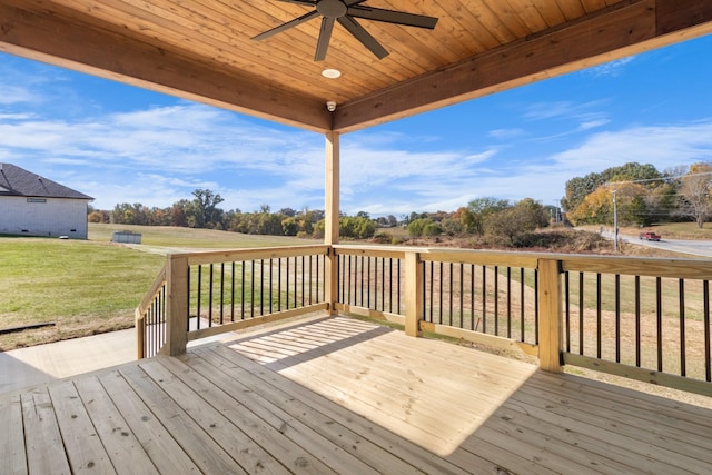 deck with a lawn and ceiling fan