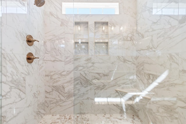 bathroom with tiled shower