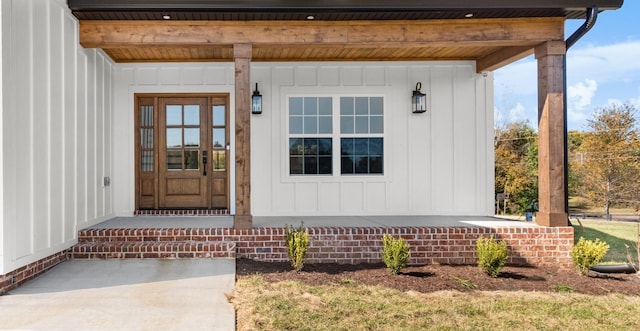 doorway to property featuring covered porch