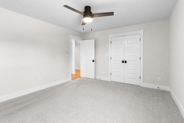 unfurnished bedroom with carpet floors, a closet, and ceiling fan