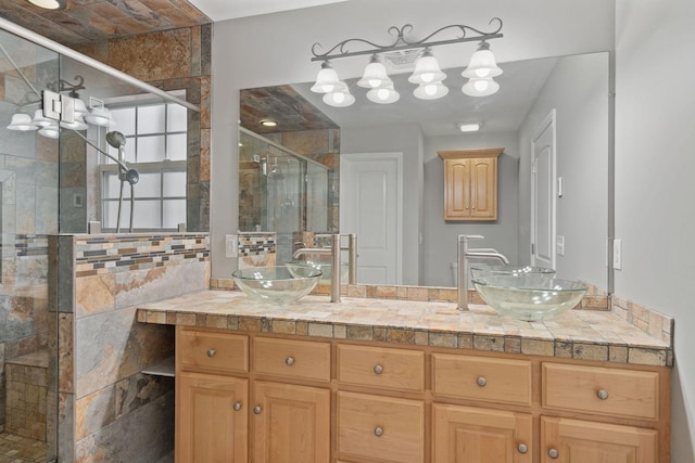 bathroom featuring vanity and a shower with shower door