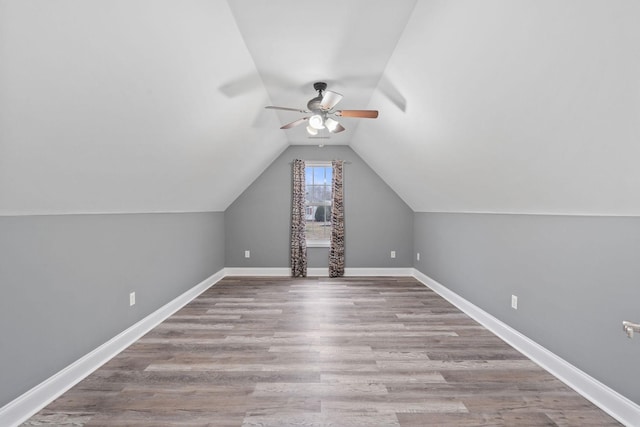 additional living space featuring lofted ceiling, light hardwood / wood-style flooring, and ceiling fan