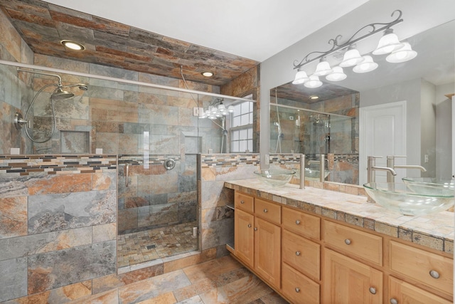 bathroom with vanity and a shower with door