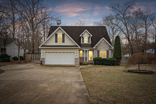 view of front facade featuring a garage and a yard