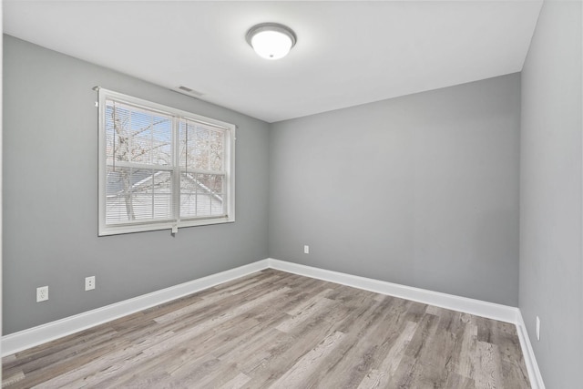 unfurnished room with light wood-type flooring