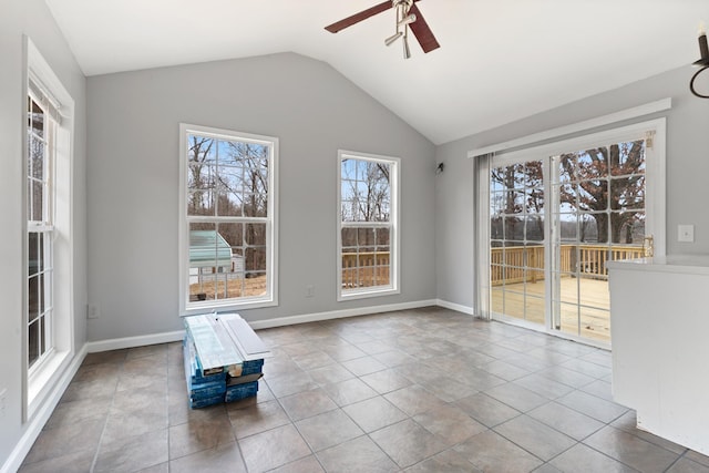 interior space featuring lofted ceiling, light tile patterned floors, and ceiling fan