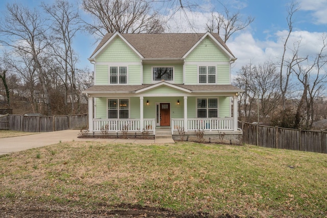 view of front of property with a front yard and covered porch