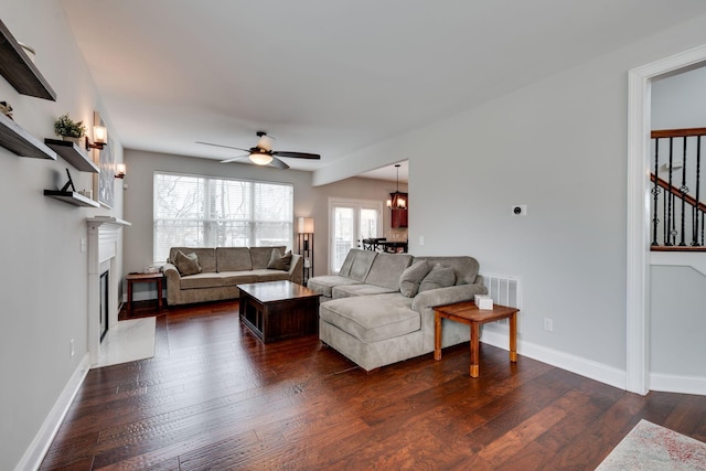 living room featuring dark hardwood / wood-style floors and ceiling fan