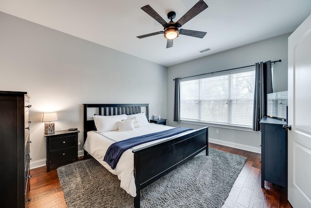 bedroom with ceiling fan and dark hardwood / wood-style floors