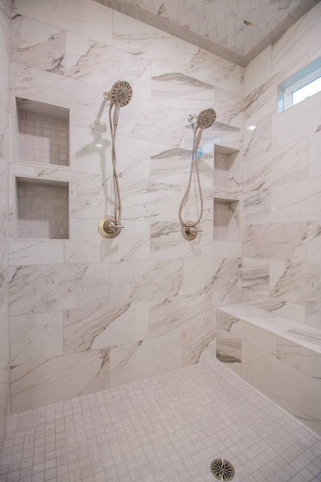 bathroom with tiled shower