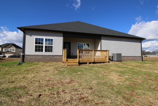 back of property featuring a deck, a lawn, and central air condition unit