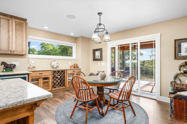 dining area with dark wood-type flooring and a healthy amount of sunlight