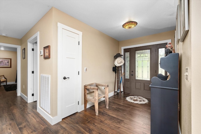 entryway with dark hardwood / wood-style flooring