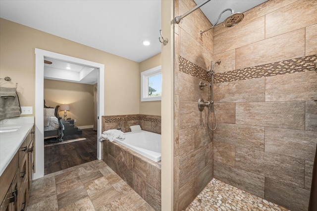 bathroom featuring vanity and plus walk in shower