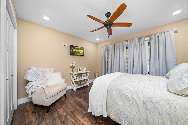 bedroom with ceiling fan, dark hardwood / wood-style flooring, and a closet