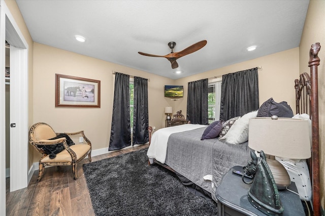 bedroom with ceiling fan and dark hardwood / wood-style floors