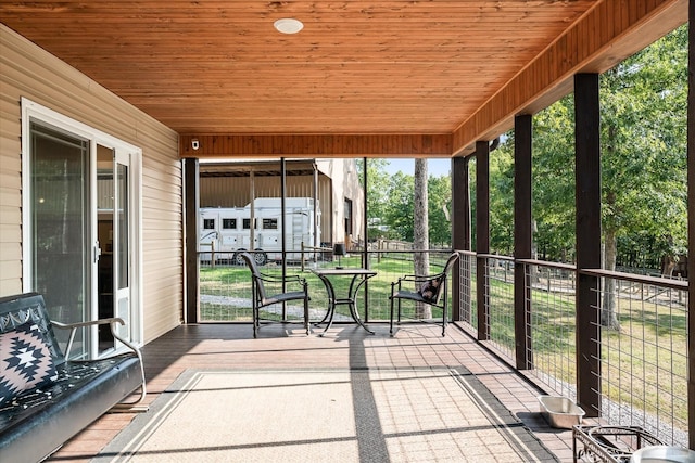 unfurnished sunroom with wooden ceiling