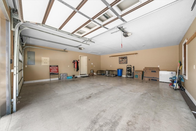 garage with a garage door opener and electric panel