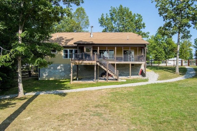 back of property with a wooden deck and a yard