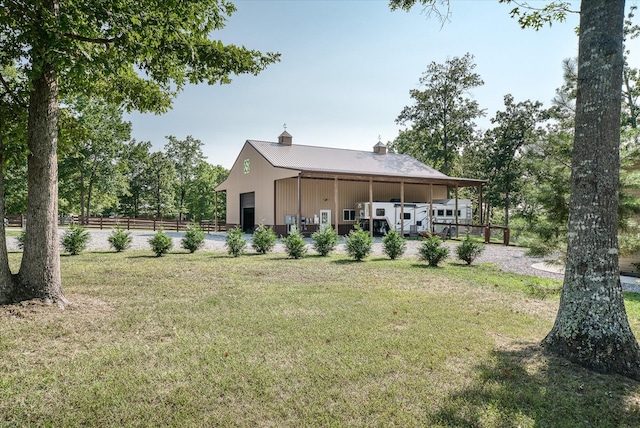 rear view of house featuring a lawn