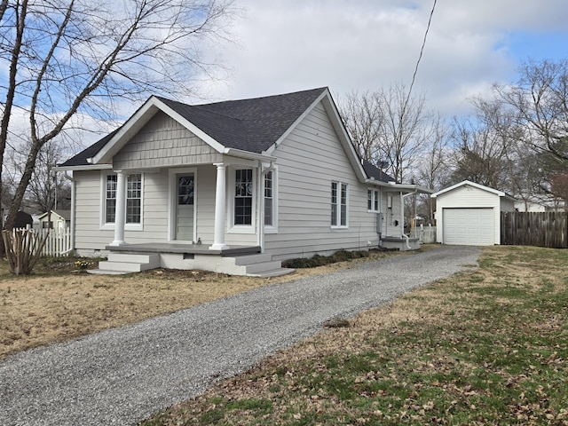 view of front of house with a garage, an outdoor structure, and covered porch