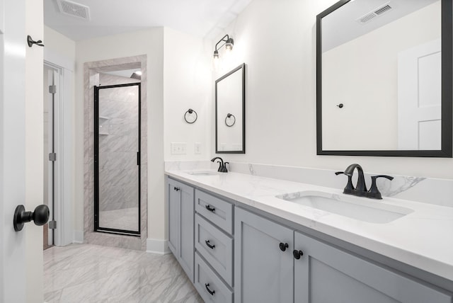 full bath with marble finish floor, visible vents, a sink, and a shower stall