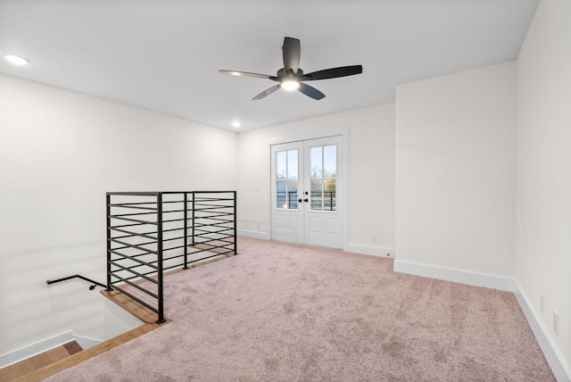 empty room featuring carpet floors, french doors, recessed lighting, and baseboards