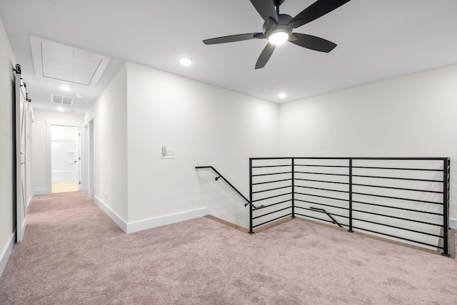 unfurnished room featuring attic access, baseboards, visible vents, and carpet flooring