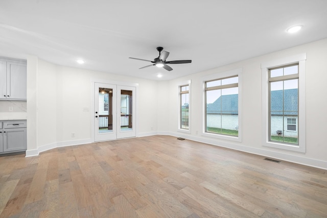 empty room with light wood finished floors, recessed lighting, visible vents, and baseboards