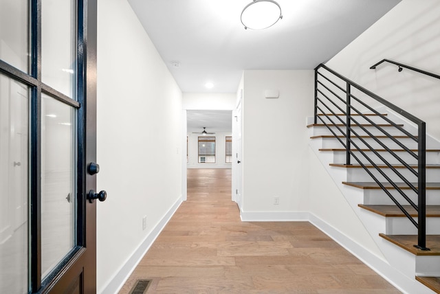 interior space featuring visible vents, baseboards, and wood finished floors