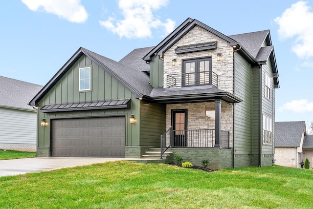 view of front of property featuring a balcony, stone siding, a front lawn, and board and batten siding