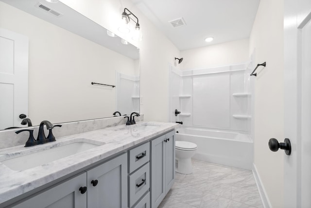 bathroom with toilet, marble finish floor, a sink, and visible vents