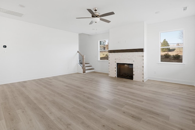 unfurnished living room featuring ceiling fan and light wood-type flooring