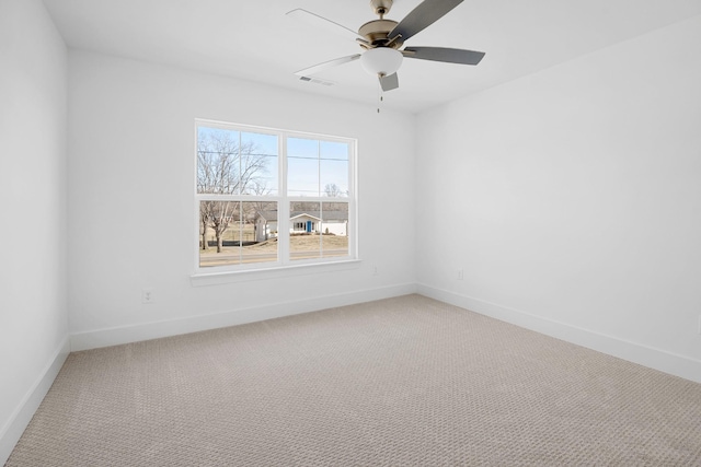 unfurnished room with ceiling fan and carpet