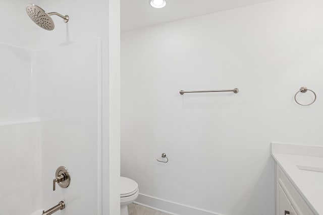 bathroom featuring a shower, vanity, and toilet