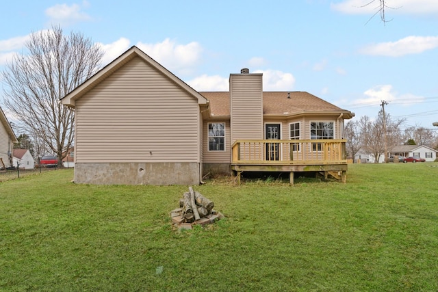 back of house with a wooden deck and a lawn