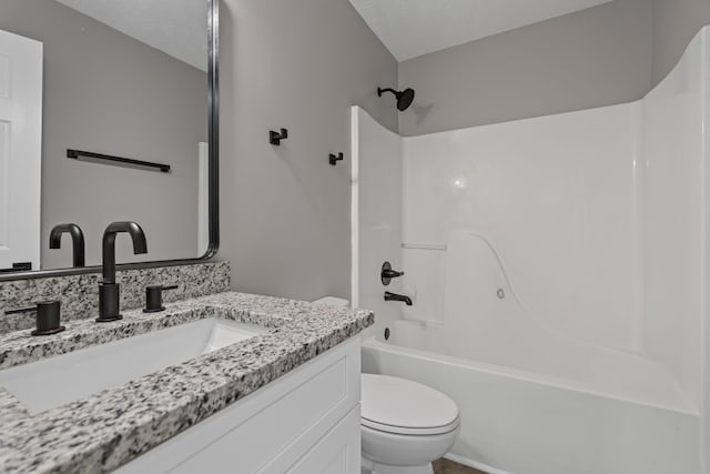 full bathroom featuring vanity, toilet, bathing tub / shower combination, and a textured ceiling