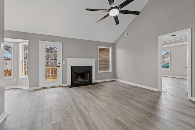 unfurnished living room featuring high vaulted ceiling, ceiling fan, and light hardwood / wood-style flooring