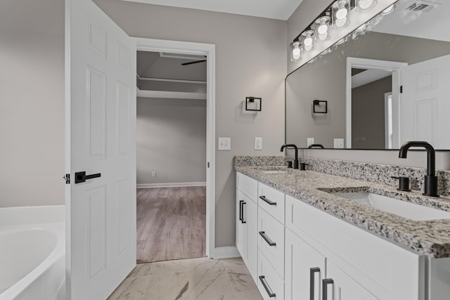 bathroom featuring a bathing tub and vanity